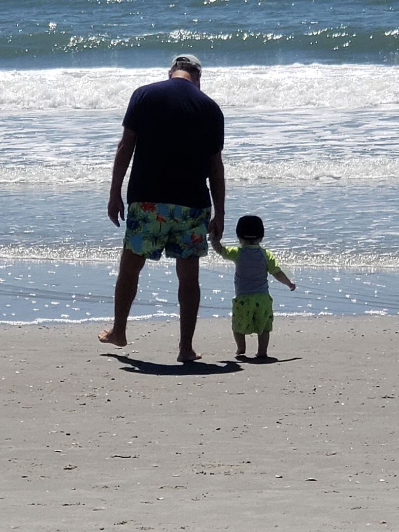 Pop and grandson first beach trip